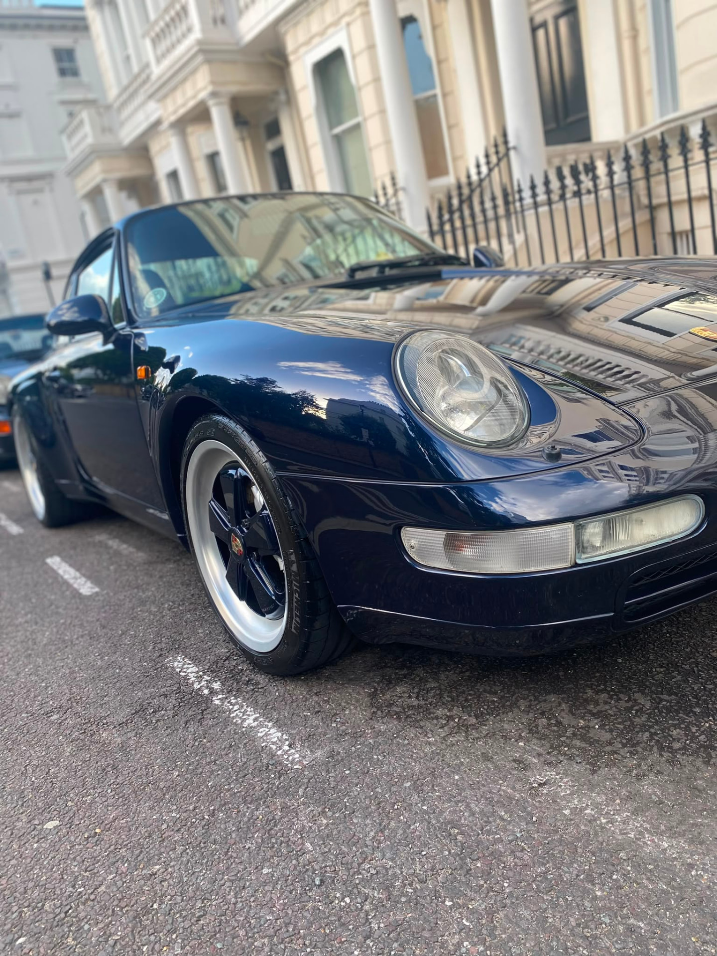Classic dark blue Porsche 911 gleaming after a full valet