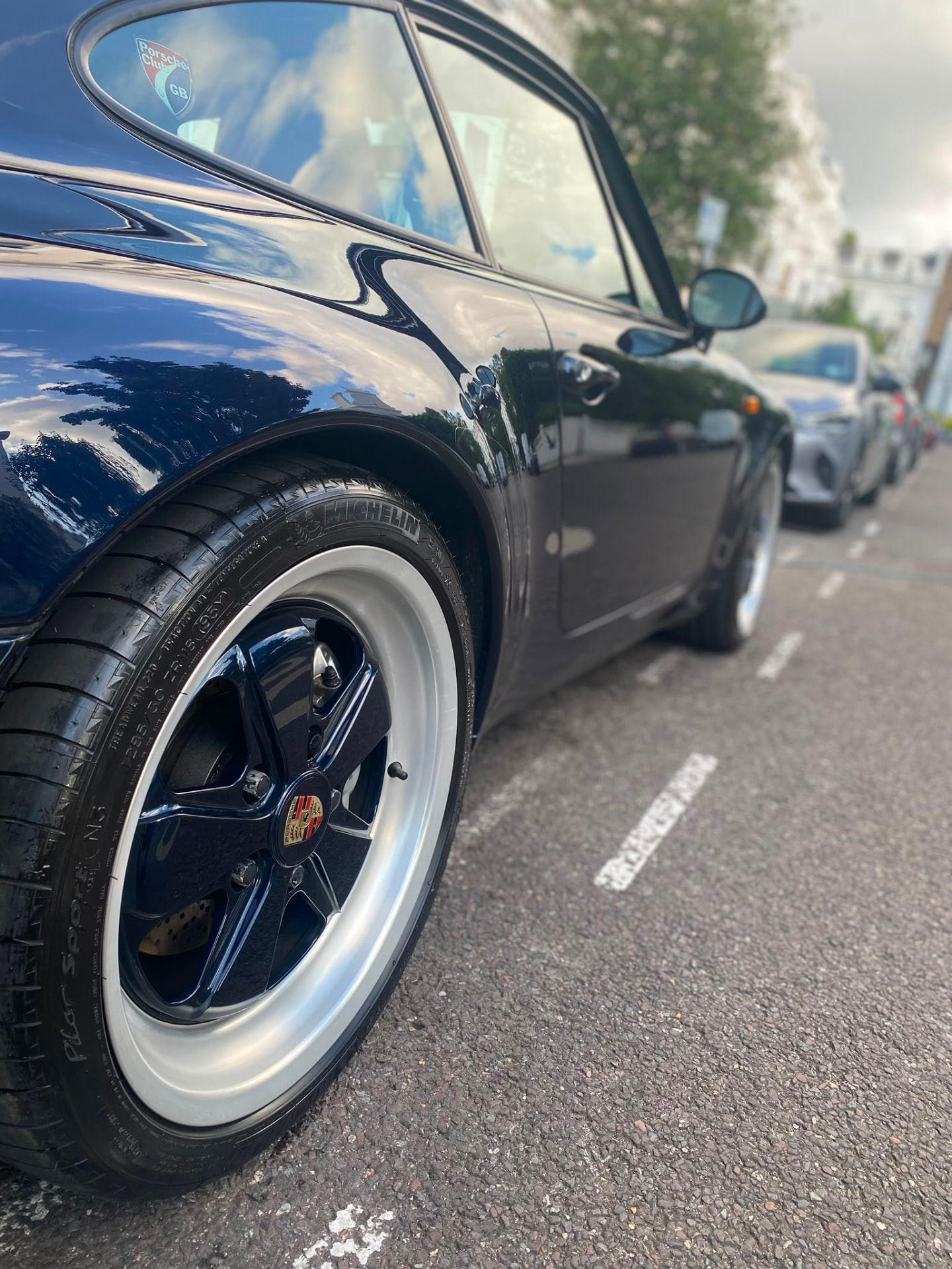 Porsche 911 wheel and polished paintwork close-up