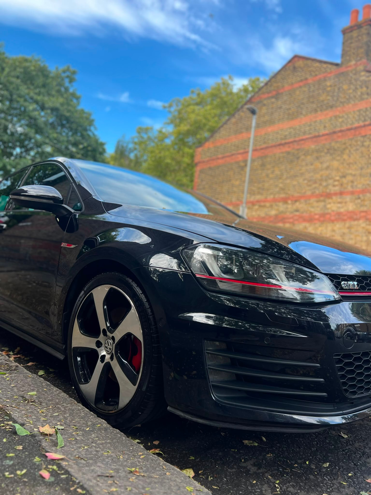 Black VW Golf GTI with deep gloss finish after detailing