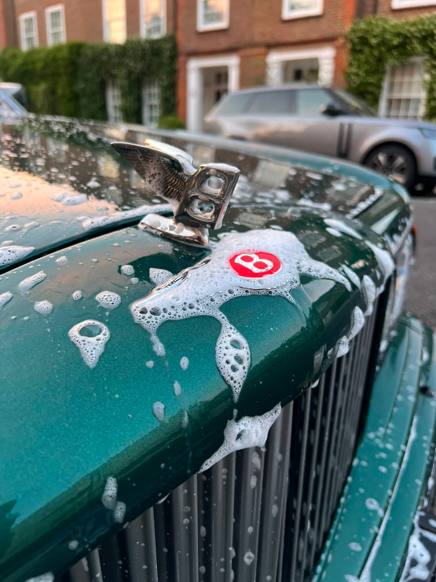Bentley bonnet covered in snow foam during a mobile detail